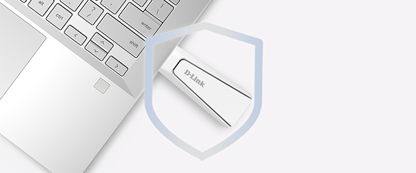 Corner of open laptop with AX18U USB adapter plugged in, overlayed with network security shield.