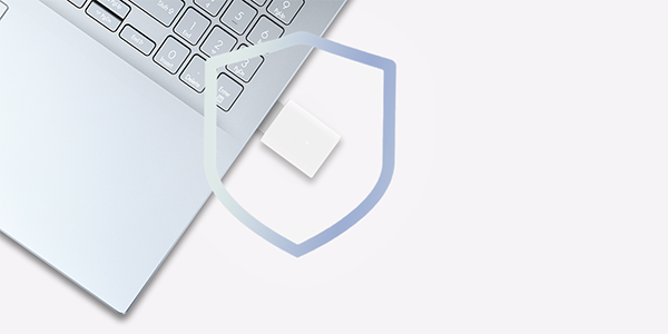 Laptop with overlayed with shield graphic to highlight enhanced network security.