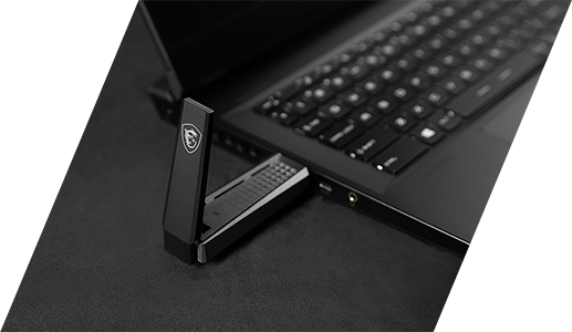 AX1800 USB WiFi adapter plugged into laptop.
