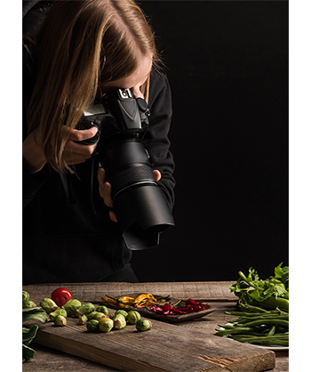 Lifestyle image of a woman photographing food ingredients