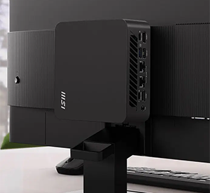 MSI Cubi mounted behind a MSI monitor.