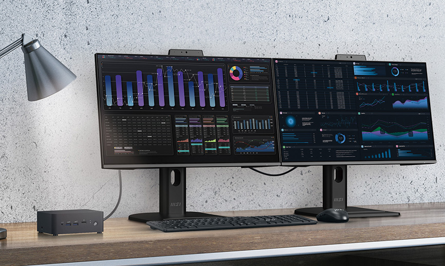Two monitors daisy chained next to NUC with lamp shining on it