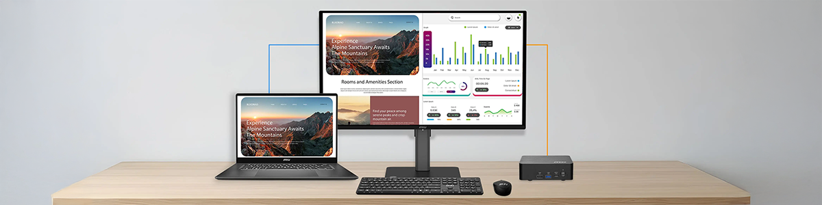 PRO MAX monitor on desk behind keyboard and mouse with laptop and mini pc either side.