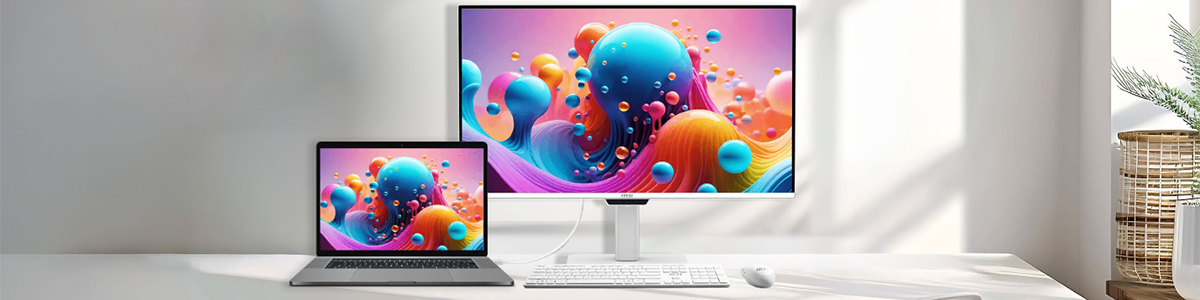 MSI monitor and laptop on a white desk.