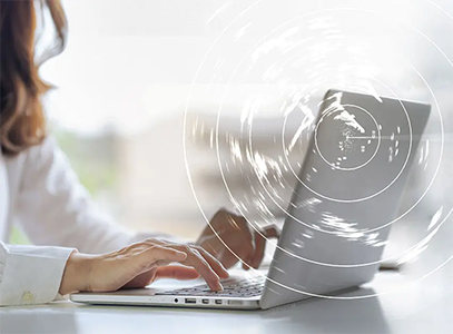 Woman typing on laptop.