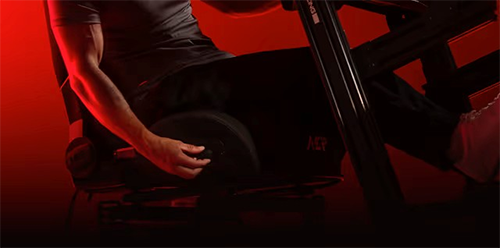 Image of a man sitting in the chair and adjusting it
