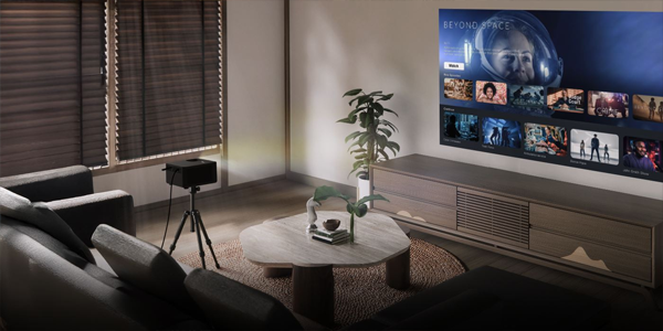 Photon Life PK31 mounted on a tripod, projecting a large movie menu screen on the living room wall