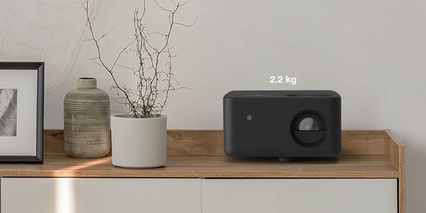 Photon Life PK31 projector on top of some desk drawers to highlight its space-saving design