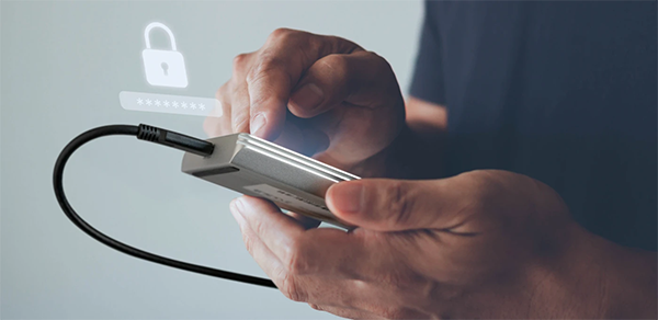 Person Holding Guardian SSD to chest and unlocking it with security lock icon