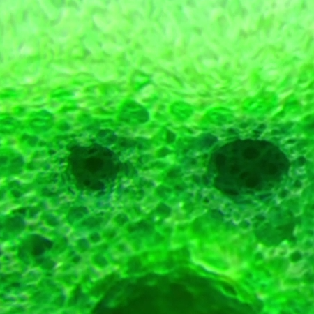 Green foam with large air bubbles pushed down a lot