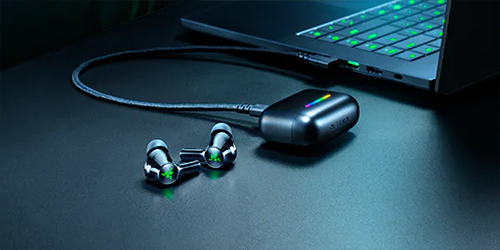 earphone sat on desk with dongle plugged into case in laptop