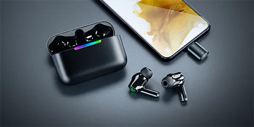 earphone set on desk with dongle plugged into phone
