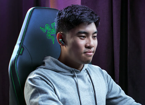 young man smiling in chair wearing earphone
