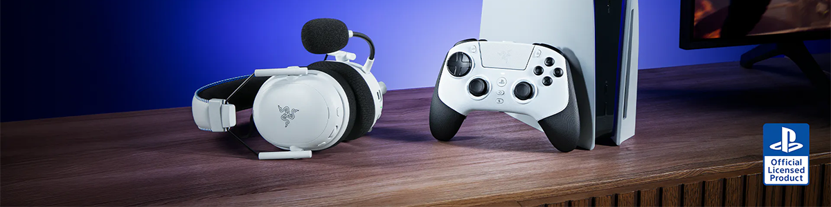 Key visual of Razer Raiju V3 Pro on a desk, perched against a PS5 with Razer headset laid flat aside.