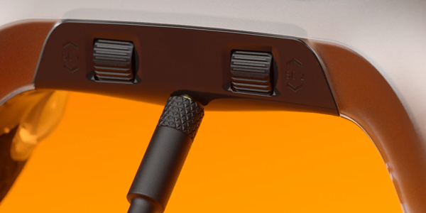 Close-up of audio controls on the bottom center edge of the controller between the grips.
