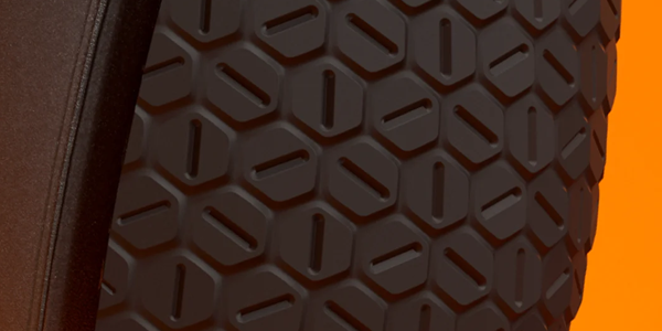 Close-up of the controller's non-slip grip with hexagonal rubber texture.