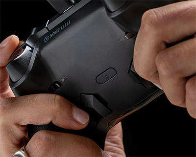 Close up image of hands holding controller