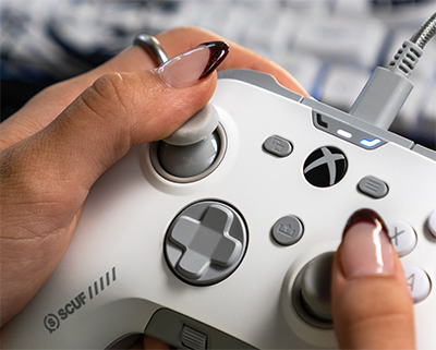 Close up image of hands holding the controller showing the thumbsticks