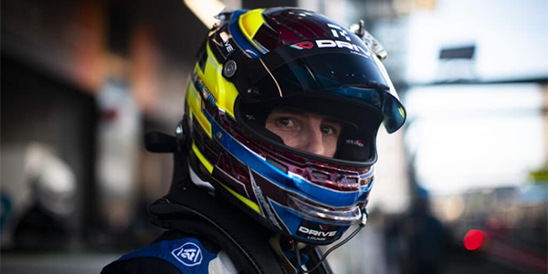 Front-angle pose of pro racer wearing a helmet