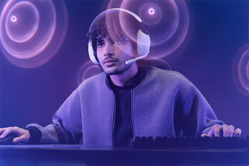 Lifestyle image of a man gaming using the INZONE H3 headphones
