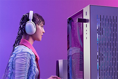 Image of woman using headset next to a PC