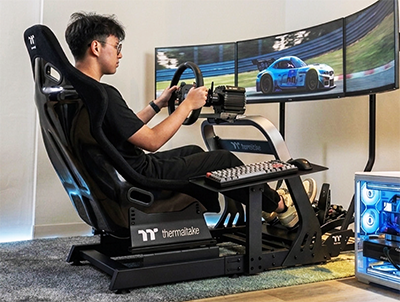 Image of a man racing a virtual car using the cockpit