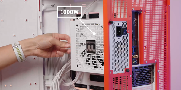 Inserting new 1000W in open PC case.