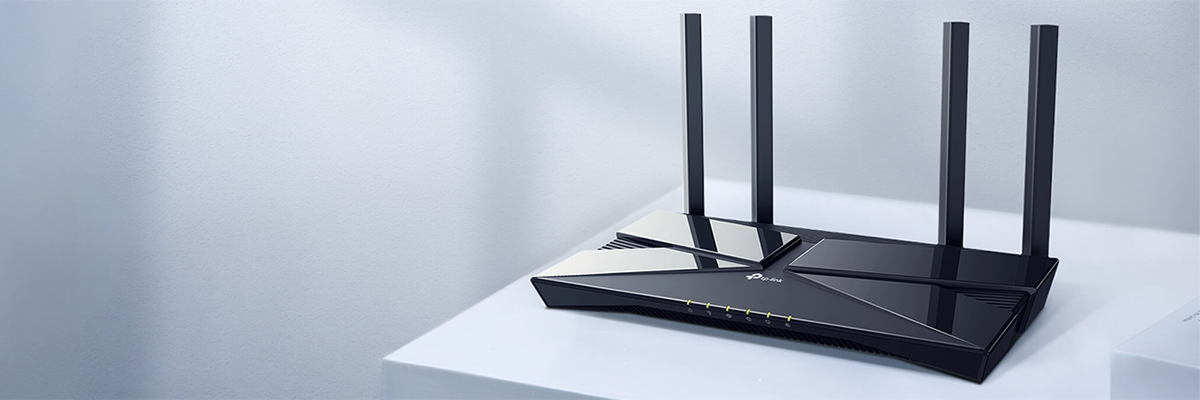 Key visual of Archer AX58 router angled atop a clear blue table with ambient blue background.