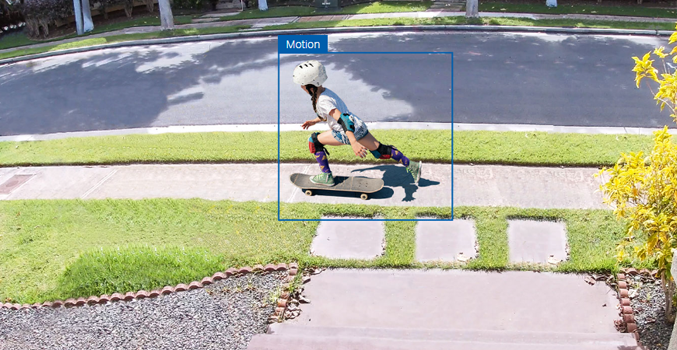 Child skateboarding on street surrounded by blue outline showing detected motion.
