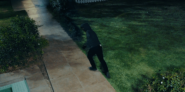 Thief in front garden at night, detected by colour night vision.