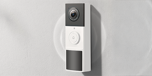 Tapo D210 doorbell mounted to white concrete wall.