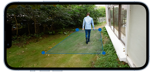 Man walking in garden beside house with custom activity zone overlaid around him.