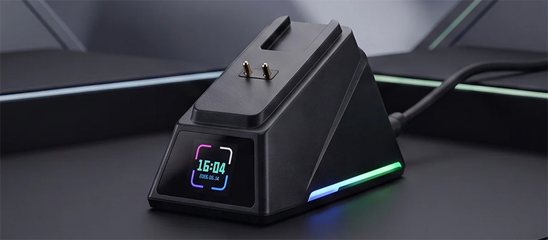 RGB control hub with LCD screen and brass charging plugs in modern backdrop