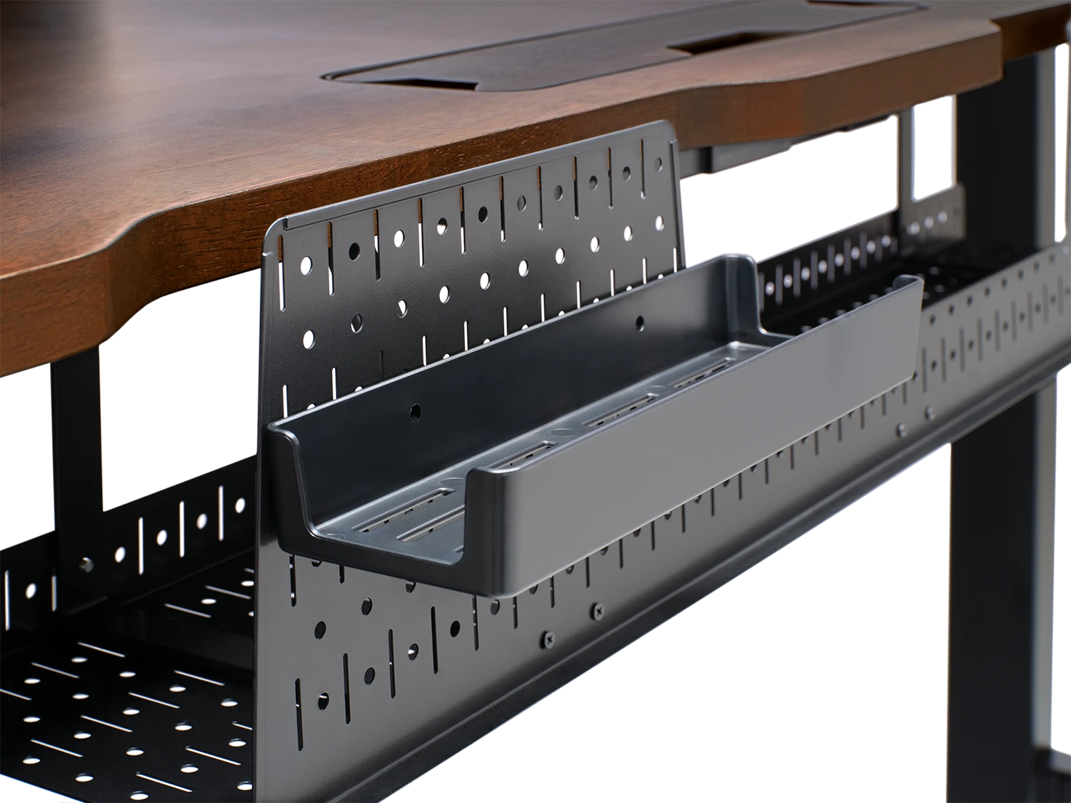 Gaming desk cable management system featuring cable trays, channels, and grommets organizing power cables, USB connections, and peripheral wiring for clean professional setup