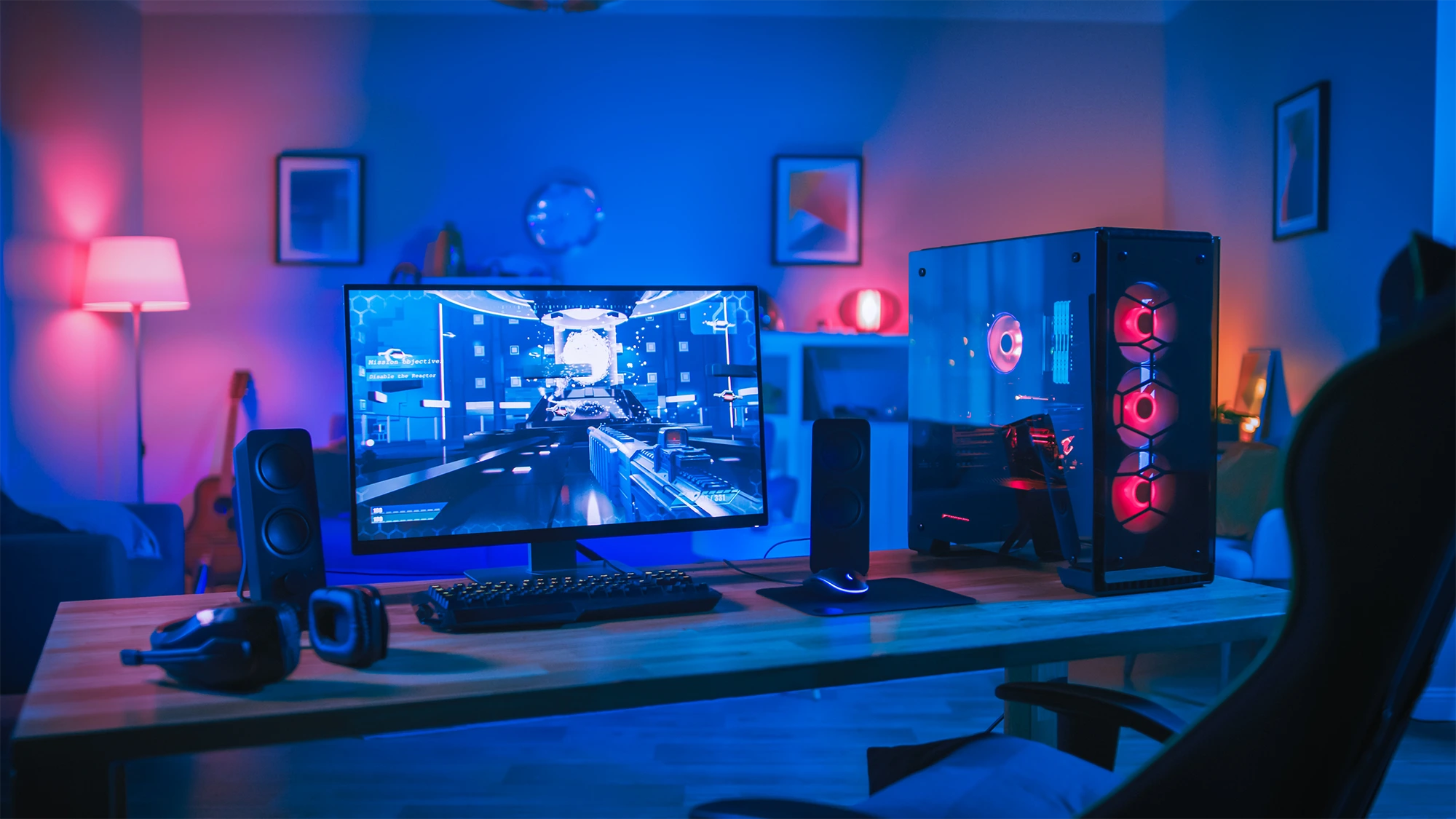 Gaming PC and monitor set up in an RGB-lit room