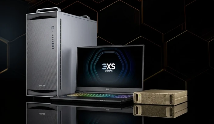High-performance workstation setup featuring a silver desktop tower, laptop with illuminated display, and compact external storage units on a dark reflective surface.
