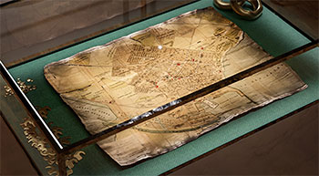 Vintage paper map rendering inside glass case