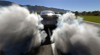 Rendered image of Car doing tire burnout generating volumetric clouds of tire smoke