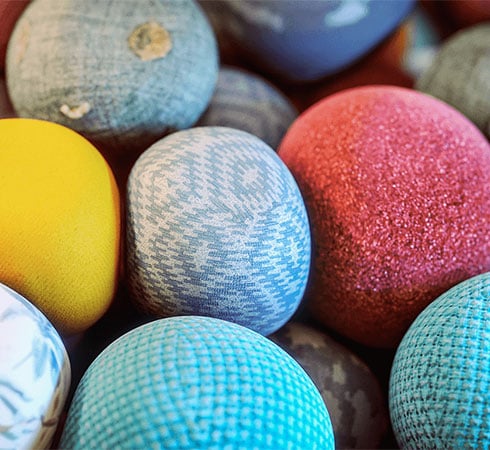 Photorealistic 3D render of fabric balls sitting on top of each other