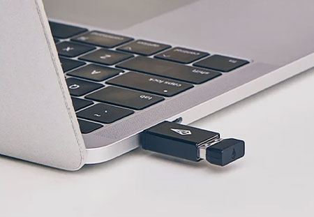 close up of the xencelabs usb dongle connected to a laptop