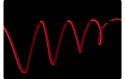 Atomos SunDragon Red LED light draped over pole on black background