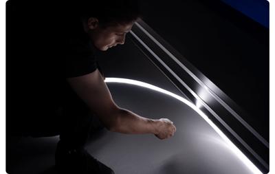 Person installing Atomos Sun Dragon LED Light into place along a wall
