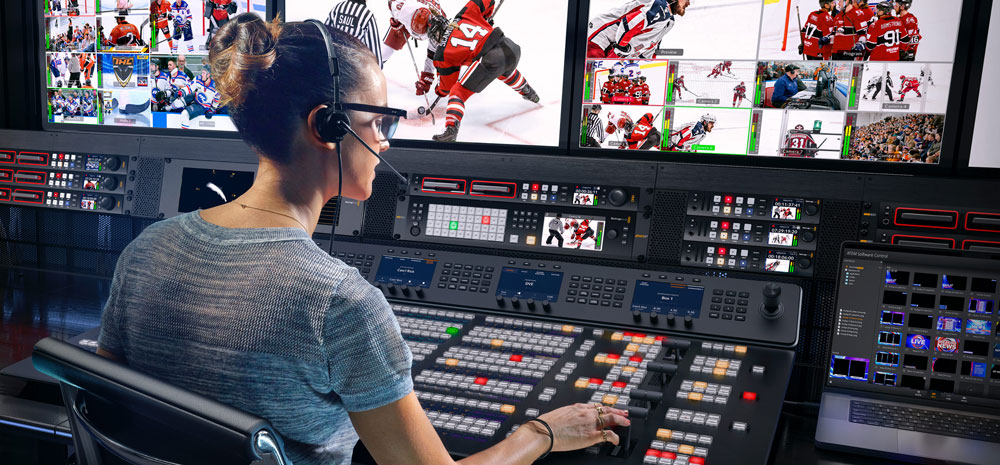 someone in a broadcast studio using the atem constellation with a controller