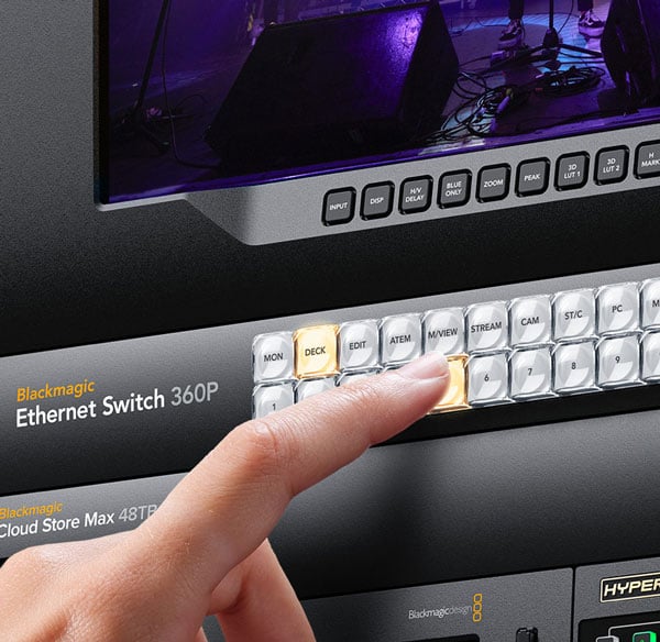 someone pressing a button on a blackmagic ethernet switch