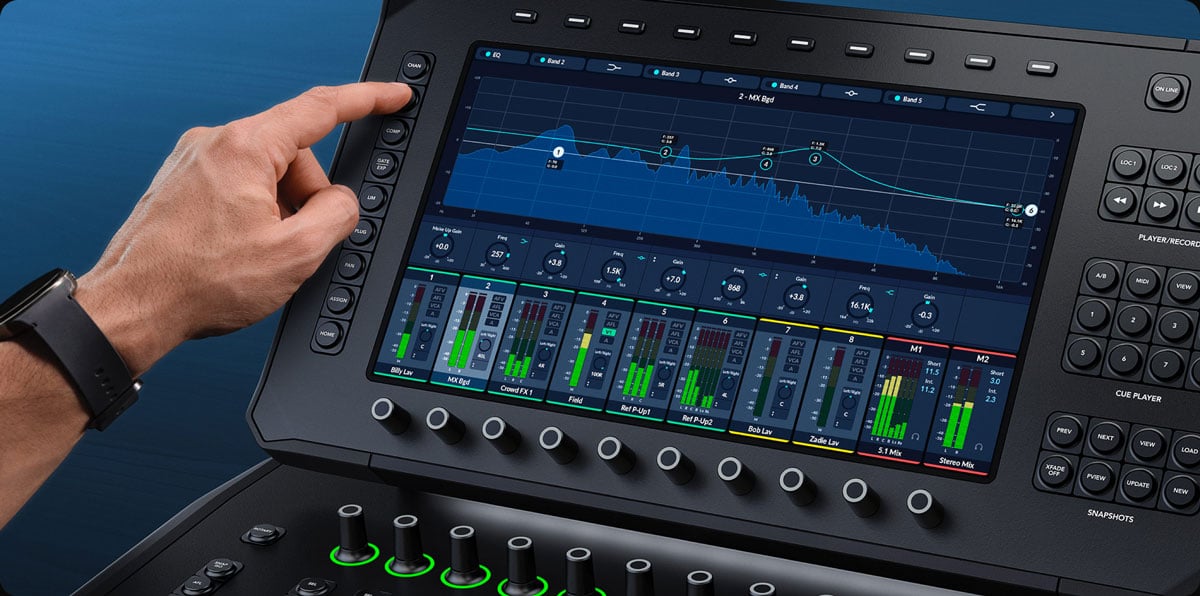A person adjusting audio settings on the large touchscreen display of a Blackmagic Design Fairlight Live Audio Panel