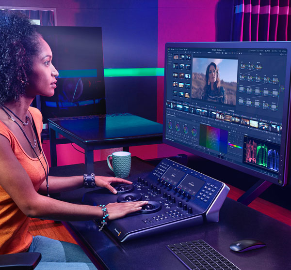 a woman in a studio editing footage taken using the blackmagic media dock ultra