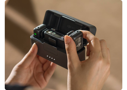 person opening DJI Charging Case and removing one microphone from the case