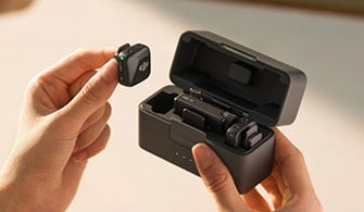 Photograph of person removing DJI Mic Mini from charge case