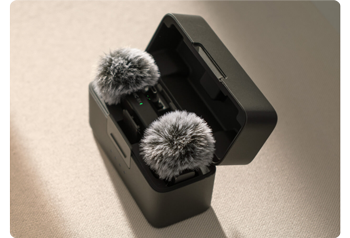 DJI Mic Mini in Charge Case with Windscreens sitting on tabletop