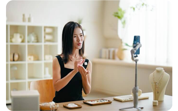 Female fashion influencer creating content with smartphone and DJI mic Mini 